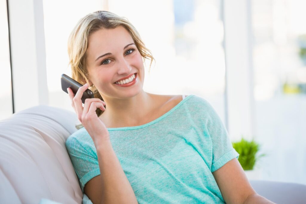 girl smiling while talking to her phone